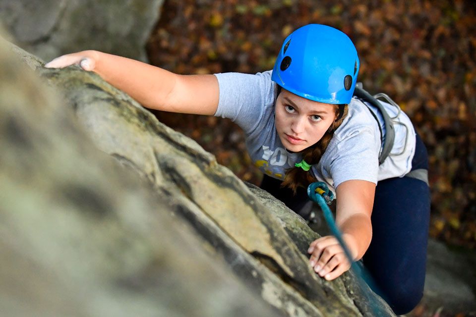 Student rock climbs