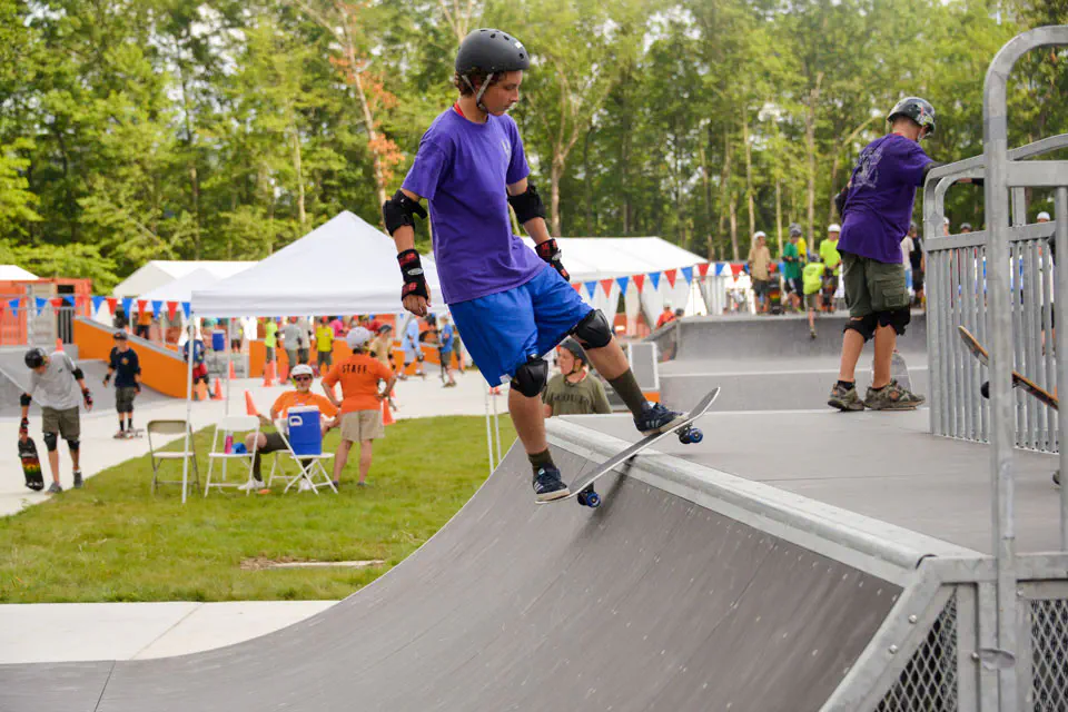 student skateboarding on a half pipe